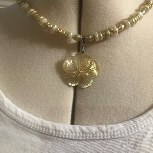Yellow shell choker style necklace with yellow beads.